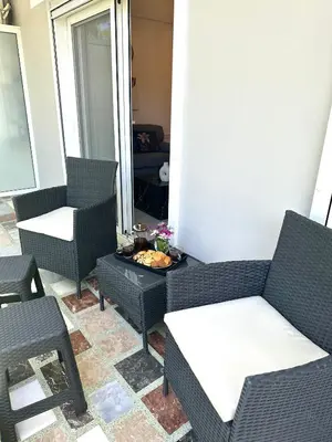 a patio with chairs and a table and a tableablish at Nice n Cosy Apartment II in Rhodes Town