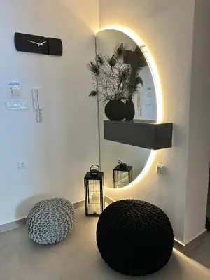 a room with two round ottomans and a mirror at Nice n Cosy Apartment II in Rhodes Town