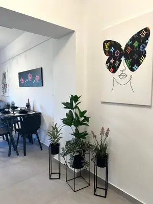 a dining room with potted plants and a table at Nice n Cosy Apartment II in Rhodes Town