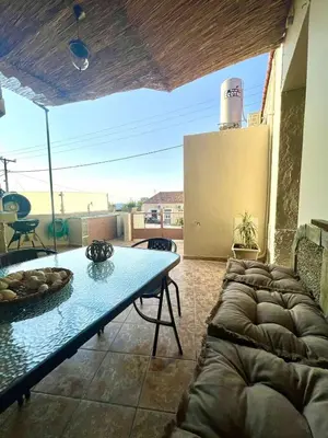 a living room with a table and a couch at Trachos Traditional House in Sálakos