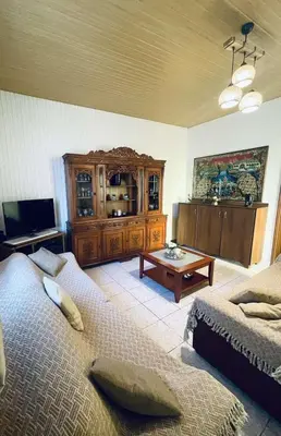 a bedroom with two beds and a wooden cabinet at Trachos Traditional House in Sálakos