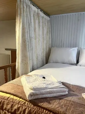 a bed with a towel sitting on top of it at Trachos Traditional House in Sálakos