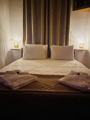 a bed with two towels sitting on top of it at Trachos Traditional House in Sálakos