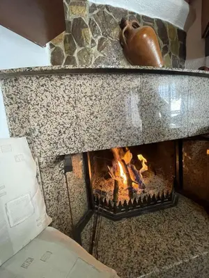 a stone oven with a fire in it at Trachos Traditional House in Sálakos