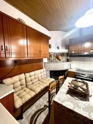 a kitchen with a couch and a table in it at Trachos Traditional House in Sálakos