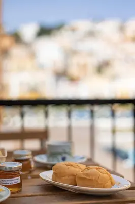 a plate of bread on a wooden table at Kantirimi House - A2 in Symi