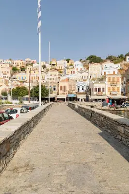 a long pier with a city in the background at Kantirimi House - A2 in Symi