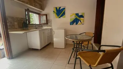 a kitchen with a table and chairs and a refrigerator at Isola Studio 2 in Rhodes Town