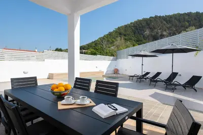 a black table with a bowl of fruit on a patio at Villa Olea in Archipolis
