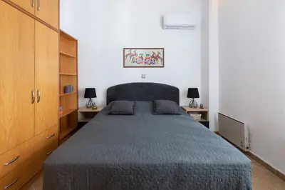 a bedroom with a large bed and two lamps at Villa Olea in Archipolis