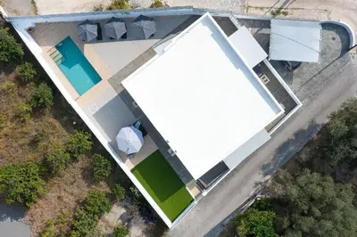 an overhead view of a large white building with a pool at Villa Olea in Archipolis