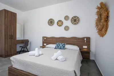 a bedroom with a bed with towels on it at Faliraki Harmony Apartments in Faliraki
