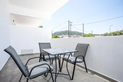a table and chairs on a balcony with a view at Faliraki Harmony Apartments in Faliraki