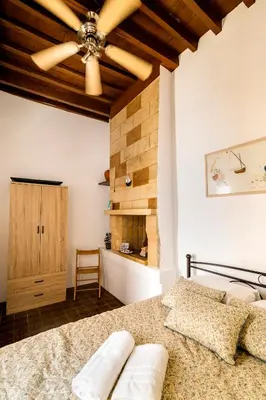 a bedroom with a bed and a wooden ceiling at Mary's house Lindos in Líndos
