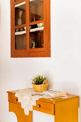 a table with a cabinet and a plant on it at Mary's house Lindos in Líndos