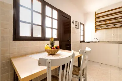 a kitchen with a table with a bowl of fruit on it at Mary's house Lindos in Líndos