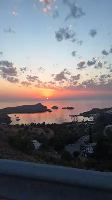 a view of a sunset over a body of water at Mary's house Lindos in Líndos