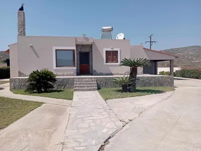 a white house with a pathway in front of it at Katavias House in Kattavía