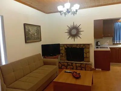 a living room with a couch and a fireplace at Katavias House in Kattavía