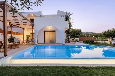 a swimming pool in the backyard of a villa at Villa Bella Natura in Afantou
