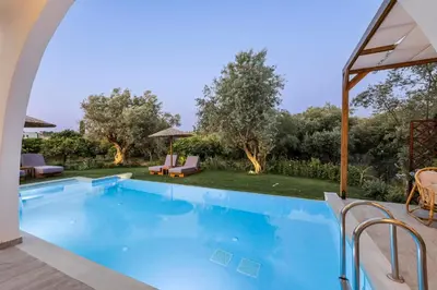 a large swimming pool with a view of a yard at Villa Bella Natura in Afantou