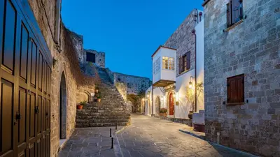 an alley in an old town at night at Kókkini Porta Rossa in Rhodes Town
