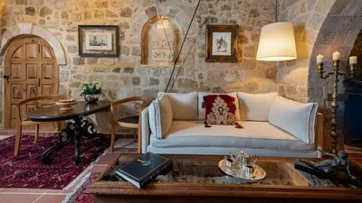 a living room with a couch and a table at Kókkini Porta Rossa in Rhodes Town
