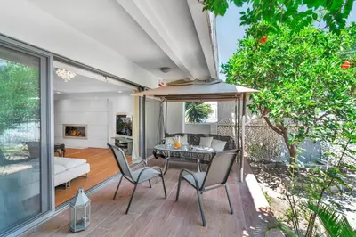 a living room with a table and chairs at Veranna Lux Apartment in Ialyssos