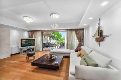 a living room with a couch and a table at Veranna Lux Apartment in Ialyssos