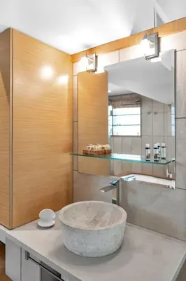 a bathroom with a large bowl sink on a counter at Veranna Lux Apartment in Ialyssos
