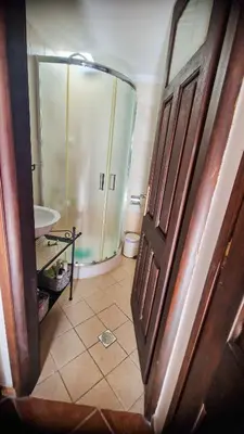 a bathroom with a shower and a toilet and a door at Unique Stes Lindos in Líndos