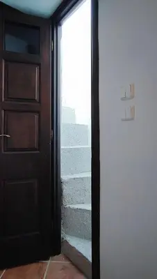 an open door with stairs leading into a room at Unique Stes Lindos in Líndos