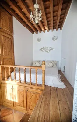 a bedroom with a bed and a chandelier at Unique Stes Lindos in Líndos