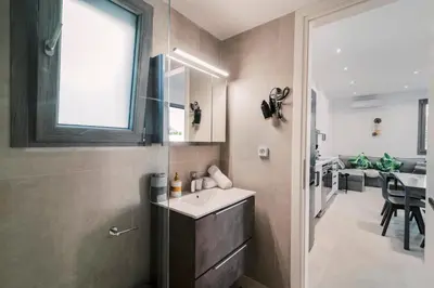 a bathroom with a sink and a window and a table at Koskinou Escape Villa in Koskinou