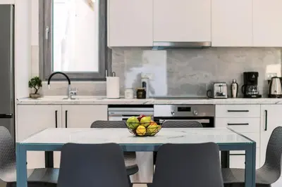 a kitchen with a table with a bowl of fruit on it at Koskinou Escape Villa in Koskinou