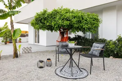 a table and chairs in front of a house at Masarou Suites in Afantou