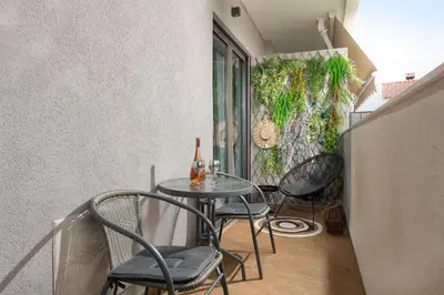 a small table and chairs in a room at Masarou Suites in Afantou