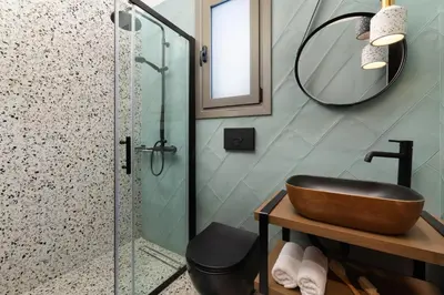 a bathroom with a sink and a shower at Masarou Suites in Afantou