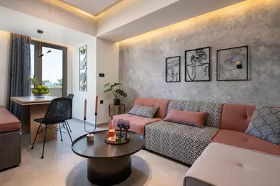 a living room with a couch and a table at Masarou Suites in Afantou