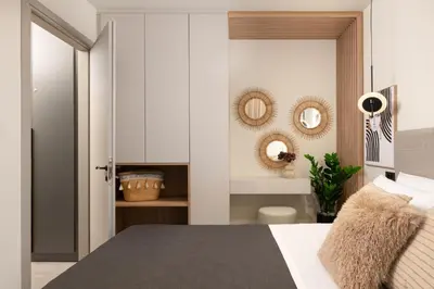 a bedroom with a bed and two mirrors on the wall at Masarou Suites in Afantou