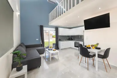 a living room with a couch and a table at Golden Sand 3 in Ialyssos