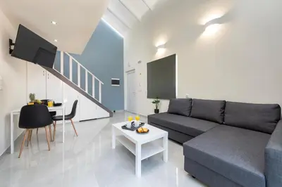 a living room with a couch and a table at Golden Sand 3 in Ialyssos