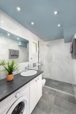 a bathroom with a sink and a washing machine at Golden Sand 3 in Ialyssos