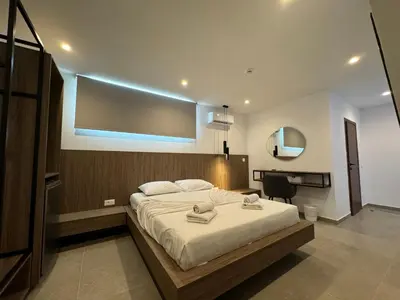 a bedroom with a large bed with a large screen at Delfinia Luxury Residence in Kolimbia