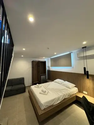 a bedroom with a large bed and a couch at Delfinia Luxury Residence in Kolimbia