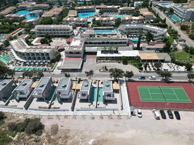 an aerial view of a parking lot with a tennis court at Delfinia Luxury Residence in Kolimbia