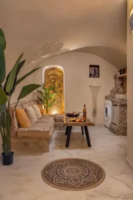 a living room with a couch and a table at Ethnic Cave Suite in Rhodes Town