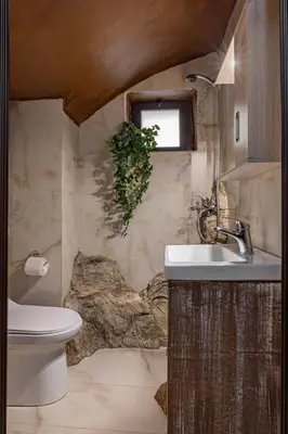 a bathroom with a sink and a toilet and a window at Ethnic Cave Suite in Rhodes Town