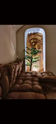 a painting of a plant on a wall behind a bed at Ethnic Cave Suite in Rhodes Town