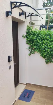 a blue welcome mat in front of a door at Villa Marina apartment Jasmine in Ixia